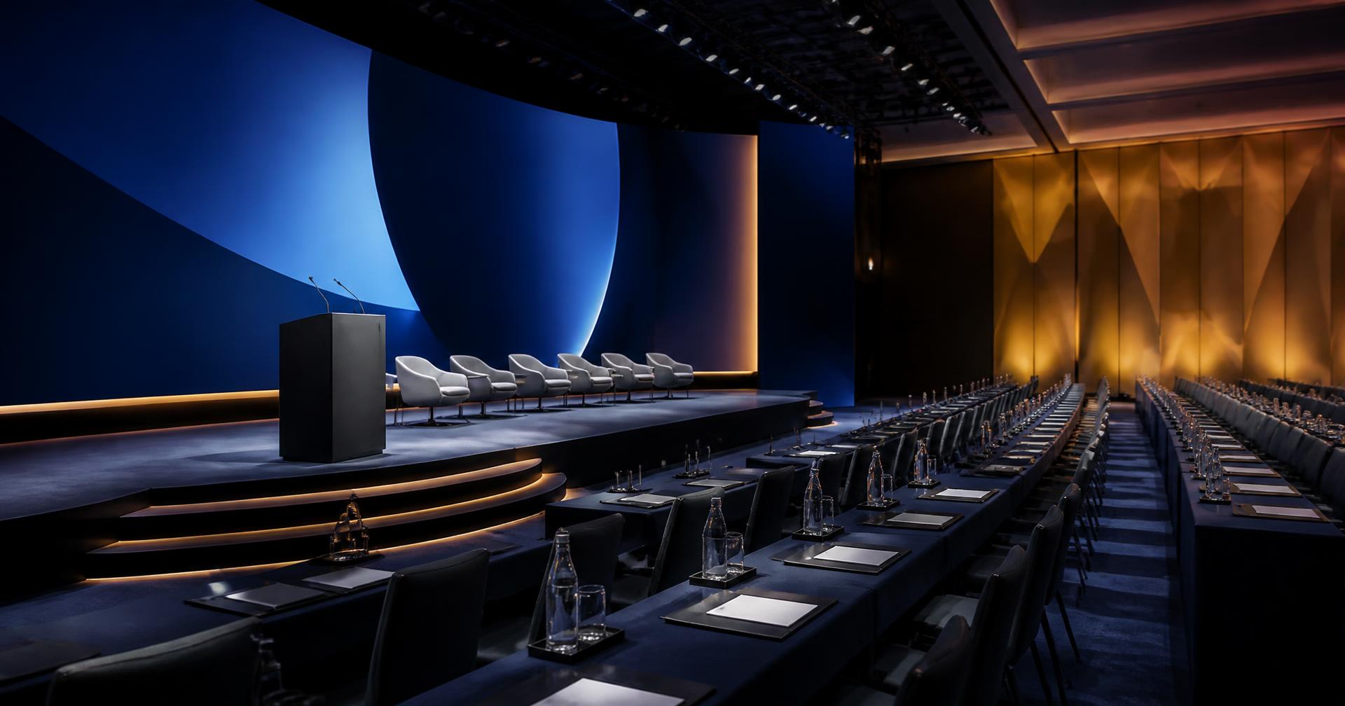 Delegate seating and stage set for an international business summit
