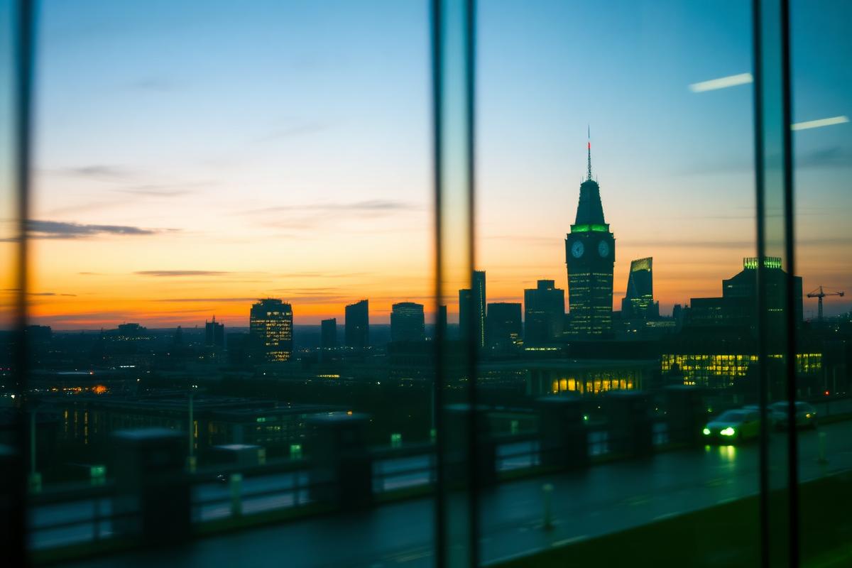 London skyline at dusk seen through the glass of a corporate office